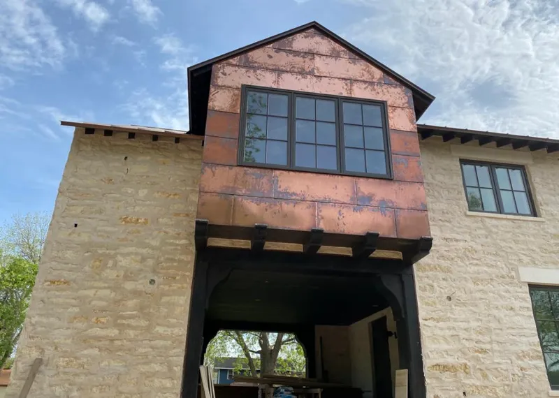 Copper metal panel facade on a stone building for Roof Repair in Fruitland Park